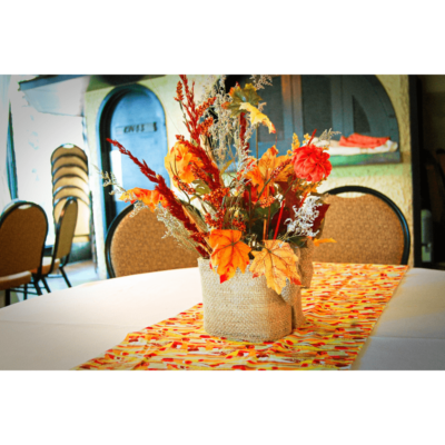 Guest table floral centerpieces and ankara runner